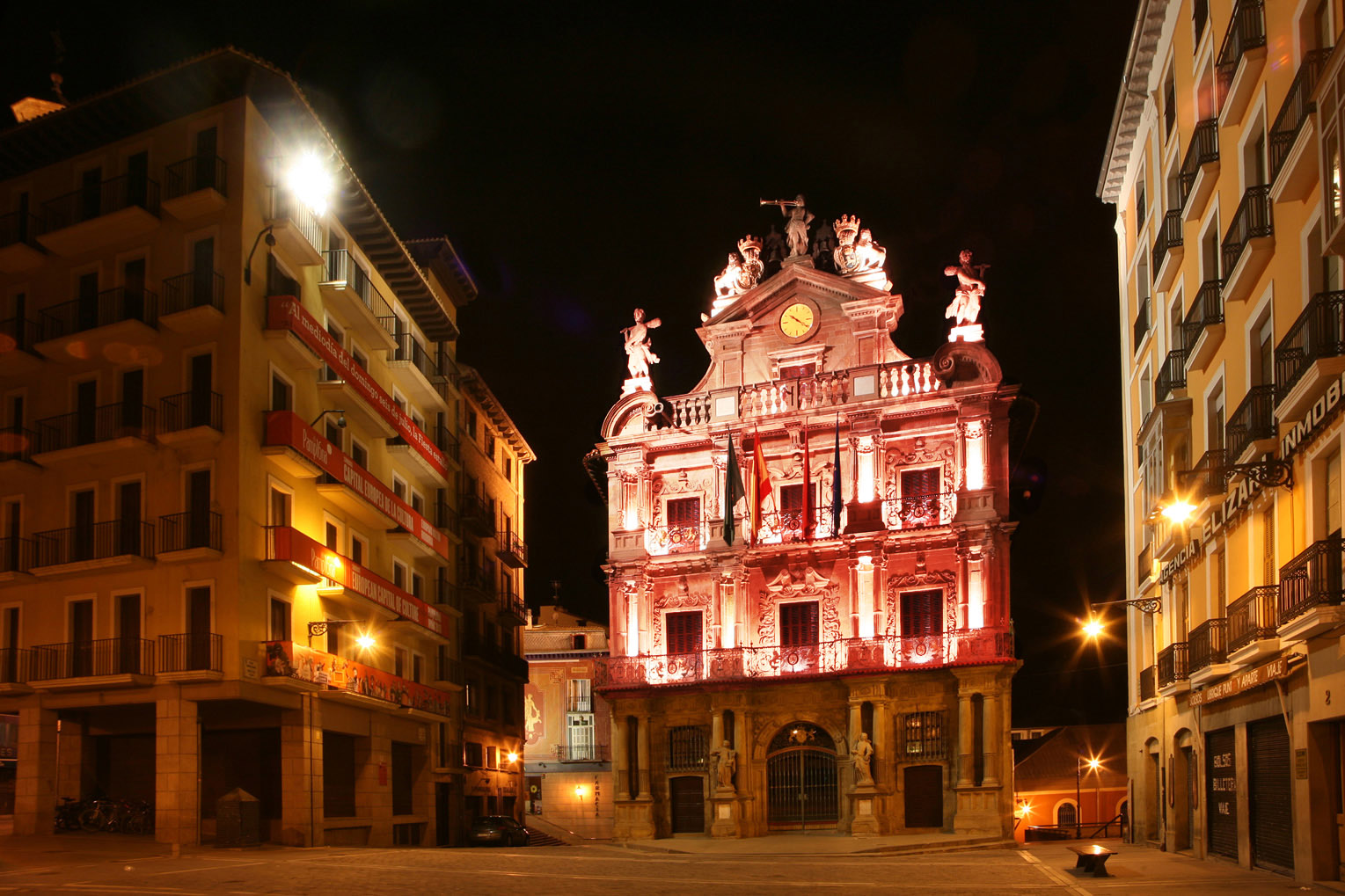 La fachada de la Casa Consistorial y el kiosko de la Plaza del Castillo, de rojo por el Día Mundial del Sida 